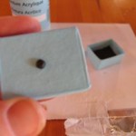 stick-a-paper-fastener-through-hole-in-lid