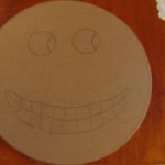 draw pumpkin face on lid