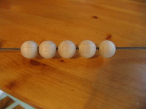 put beads on a skewer to make it easy to paint.
