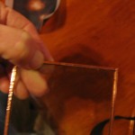 place edge of glass on center of copper foil