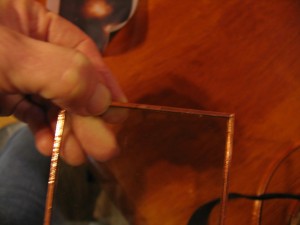 place edge of glass on center of copper foil