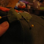 Hand sew leaves and stem on as shown