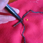 make a dot at the base of each light to mark your eyelet holes