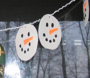punch hole in each snowman