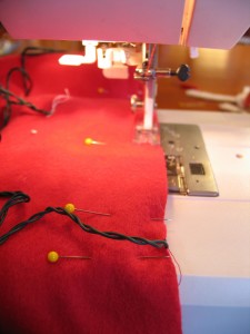 stitch along edges using a half inch seam allowance leaving the end open where your battery pack will come out.