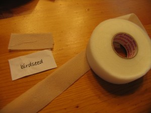 cut out birdseed peices and cut a piece of hem tape to fit