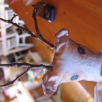 poke two holes in the head for antlers and then poke twigs in the holes and secure with hot glue