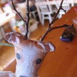 oke two holes in the top of the head and then poke twigs in the holes for antlers