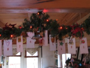 using a decorative hook hang a candy cane each day to mark the days till christmas
