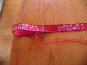 make a loop at each end of decorative ribbon and stitch