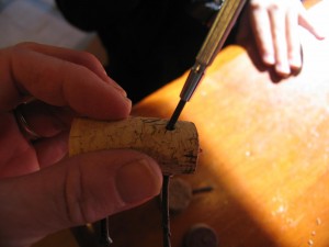 punch a hole in the top of the cork for the head