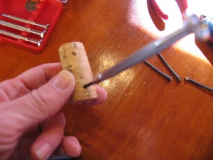 using a small punch make four holes in the bottom for the twig legs