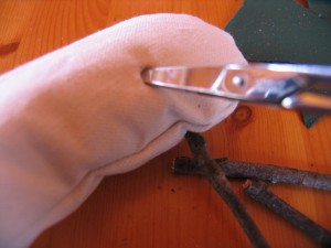 punch four holes in the underside of the body using an icepick or sharp pointed scissors