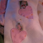 slip post cards inside of hearts and pin in place