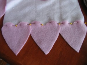 pin three hearts to each edge of scarf.