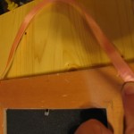 attach ribbon to back of frame using a staple gun or nails