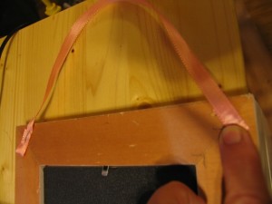 attach ribbon to back of frame using a staple gun or nails