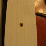 paint or stain board and then drill holes for knobs