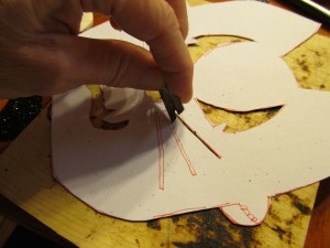 cut out eyes, mouth, whiskers.