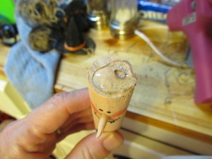 glue hat on top of dowel with hot glue