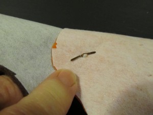 open up paper fastener to secure