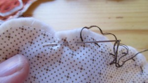 stitch fabric to quilt batting using a running stitch