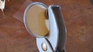 punch hole in top of tag using a brad fastener or anything that will make a clean hole.
