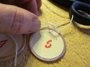 tie each tag to the long piece of string