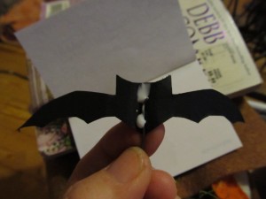 put a line of glue in the center of your bat cut out