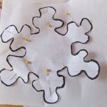 cut a snowflake from each color of felt and also from stiff pellon