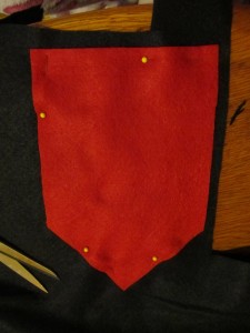 cut out a black piece slightly larger than the red piece