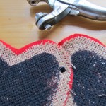 overlap the hearts and punch a hole as shown. Stick a paper fastener through the hole to join the hearts.