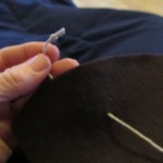 tie a knot at end of thread and push needle through