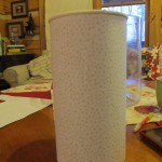 cover the oatmeal container with scrapbook paper or paint it