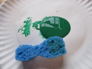 green washable paint and a damp sponge